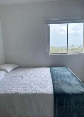 a bedroom with a bed and a large window at Espectacular vista a la Ciudad in Cartagena de Indias