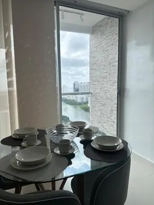 a dining room table with a view of a river at Espectacular vista a la Ciudad in Cartagena de Indias