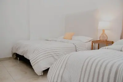 two beds with striped blankets in a bedroom at Apartamento Benitez 301 by Zakher in Cartagena de Indias