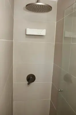 a shower stall with a shower head and a shower at Serenity by the Sea in Juan de Acosta