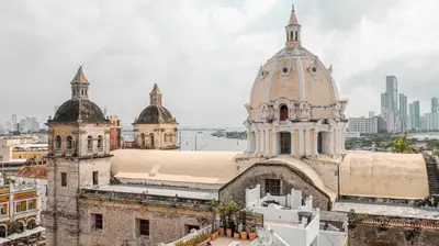 an old building with two towers with a city in the background at Cozy apartment in the old city 421 in Cartagena de Indias
