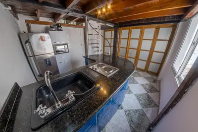 a kitchen with a sink and a refrigerator at Cozy apartment in the old city 421 in Cartagena de Indias