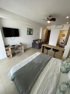 a bedroom with a bed and a living room at Crespo Horizon Suite in Cartagena de Indias