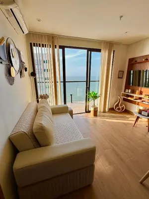 a living room with a couch and a view of the ocean at Murano Centro1 26floor,rooftop,infinity pool & views byIMZ in Cartagena de Indias