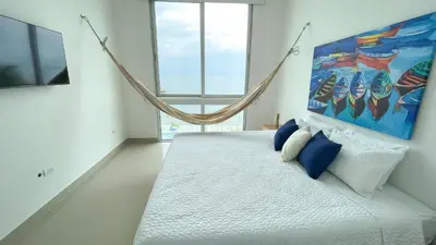 a bedroom with a swinging bed with a painting on the wall at Magico Apartamento Frente al Mar 4 Habitaciones BM43 in Coveñitas
