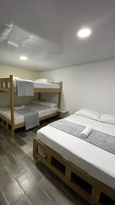 two beds in a room with two bunk beds at Hotel Casablanca in Galapa
