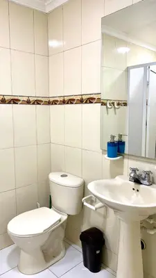 a white bathroom with a toilet and a sink at apartamento con vista al Lago in Cartagena de Indias