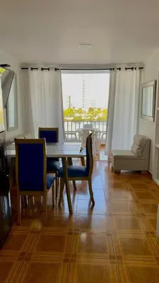 a dining room with a table and chairs and a couch at apartamento con vista al Lago in Cartagena de Indias