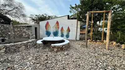 a bench with a painting on the side of a building at Cabañas en Cartagena JhonliMar in Isla de Tierra Bomba