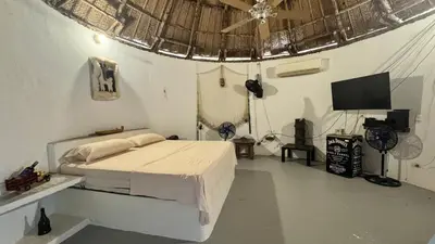 a bedroom with a bed and a flat screen tv at Cabañas en Cartagena JhonliMar in Isla de Tierra Bomba
