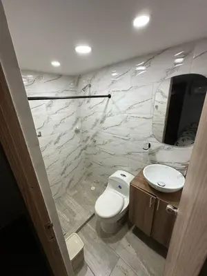 a bathroom with a white toilet and a sink at Cozy apartment in the heart of Barranquilla in Barranquilla