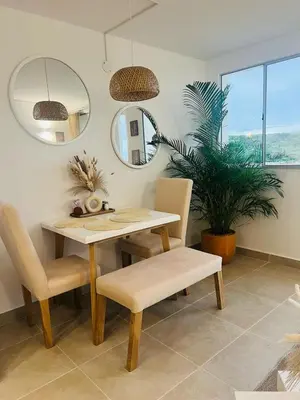 a dining room with a table and chairs and a mirror at Apartamento Descanso Cartagena in Manzanillo del Mar