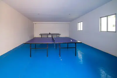 a ping pong table in a room with a blue floor at Magico Apartamento Frente al Mar 3 Habitaciones AR12 in Coveñas