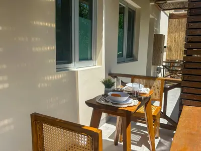 a wooden table and chairs on a patio at Despierta en Tolú, un escenario de película in Tolú