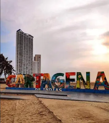 a sign on the beach in front of a city at Cabrero Beach 1008 in Cartagena de Indias