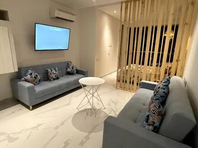 a living room with two couches and a flat screen tv at sui lofts 1609 in Santa Marta