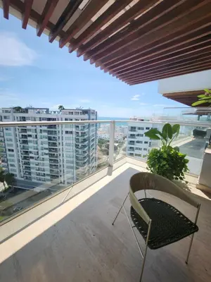a balcony with a chair and a view of the city at Martinique 1001 luxure escape & comfort in Cartagena de Indias
