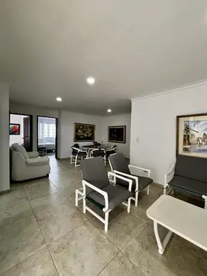 a living room with couches and chairs and a table at Apartamentos en Bocagrande frente al mar in Cartagena de Indias