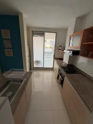 a large kitchen with a sink and a stove at Refugio junto al mar en el Cabrero in Cartagena de Indias