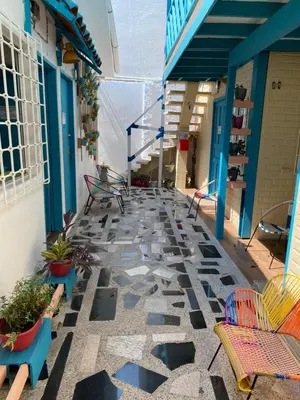 a patio with chairs and tables on a building at Apartaestudios Ofir in Barranquilla