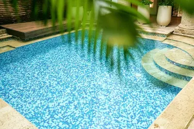 a large blue swimming pool in a building at Hotel Boutique Patio Corao in Cartagena de Indias