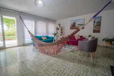 a room with a hammock in a living room at Casa Caribe, excellent location in Bocagrande in Cartagena de Indias