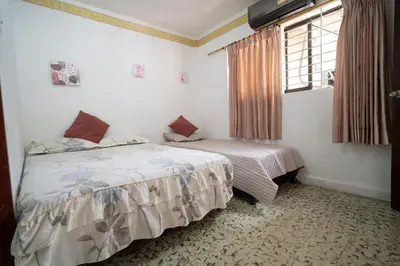 a bedroom with a bed and a window at Casa Caribe, excellent location in Bocagrande in Cartagena de Indias