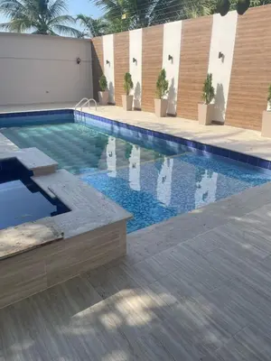 a swimming pool with blue water in a building at Luxury cabin in Santa Veronica in Santa Veronica