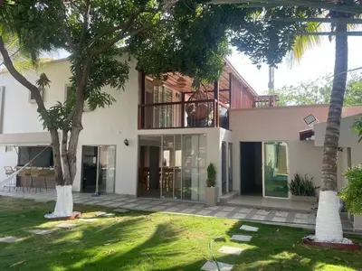 an exterior view of a house with palm trees at Luxury cabin in Santa Veronica in Santa Veronica