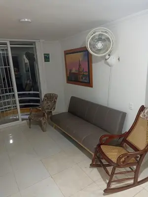 a living room with a couch and a fan at Confortable y comodo apartamento in Cartagena de Indias
