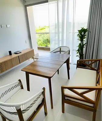 a dining room with a wooden table and two chairs at 1ra Cristal Lagoons de Colombia in Cartagena de Indias