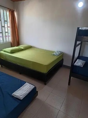 a bedroom with a bed and a ladder in it at Las Margaritas Frente al Mar 2 in Coveñas
