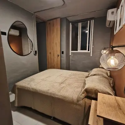 a small bedroom with a bed and a mirror at Exclusive apartament near downtown and beach in Cartagena de Indias