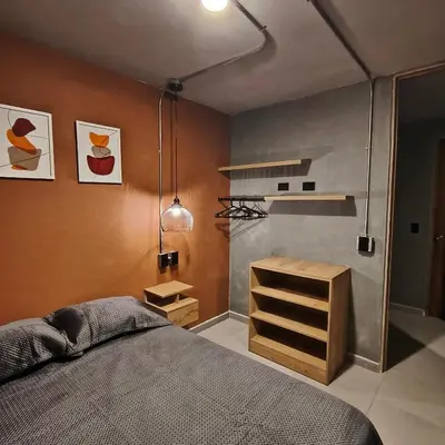 a bedroom with a bed and a wooden cabinet at Exclusive apartament near downtown and beach in Cartagena de Indias
