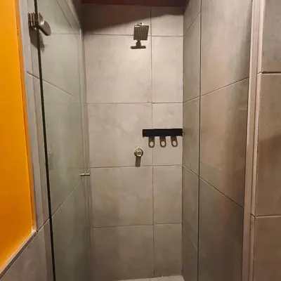 a shower with a glass door in a bathroom at Exclusive apartament near downtown and beach in Cartagena de Indias