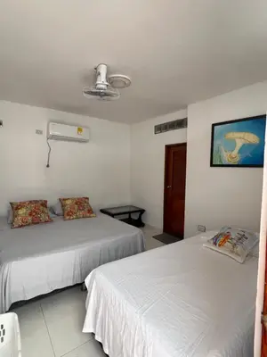 a room with two beds and a window at Asís apartamentos in Tolú