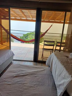 a bedroom with a bed and a view of a patio at Alta vista Turbaco in Cartagena de Indias