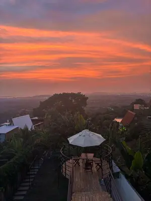 an umbrella sitting on top of a deck at sunset at Alta vista Turbaco in Cartagena de Indias