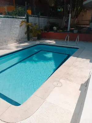 a large swimming pool with blue water at Habitación con aire y piscina in Santa Veronica