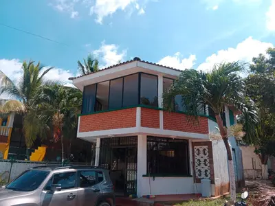 a house with a car parked in front of it at Habitación con aire y piscina in Santa Veronica