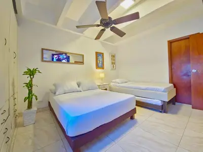 a bedroom with two beds and a ceiling fan at Apartamento Caribe Hilton View - Piso 7 in Cartagena de Indias