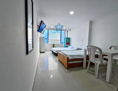 a bedroom with a bed and a table and a tv at Estudio Vista Mágica - Piso 17 in Cartagena de Indias