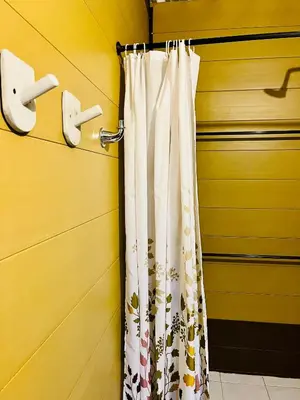 a shower curtain on a door in a room at Aquarius Diving Club y Cabañas in Rincón
