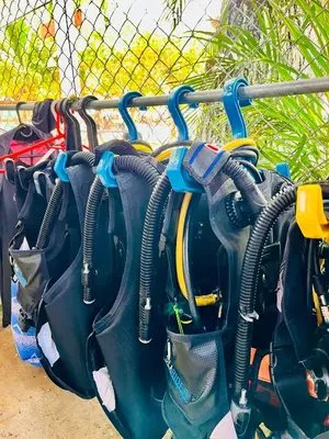 a bunch of bags hanging on a fence at Aquarius Diving Club y Cabañas in Rincón