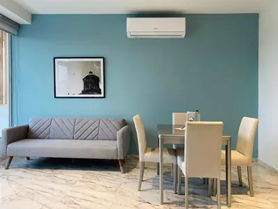 a living room with a couch and a table with chairs at Muralla by Wynwood House in Cartagena de Indias