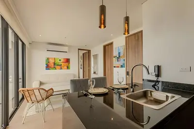 a kitchen with a sink and a living room at Vista al Mar/ Centro Histórico/ Nuevo Piso 26 1BR in Cartagena de Indias