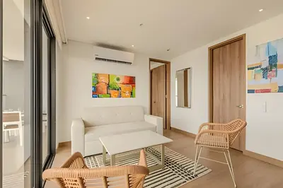 a living room with a white couch and chairs at Vista al Mar/ Centro Histórico/ Nuevo Piso 26 1BR in Cartagena de Indias