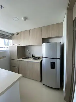 a kitchen with a white refrigerator and a stove at Gran y cómodo Loft en Cartagena in Cartagena de Indias