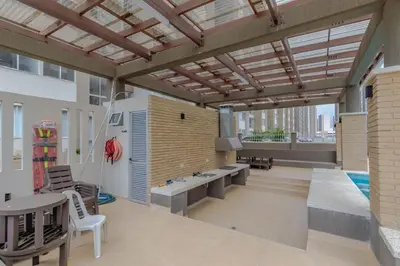 a patio with a pool and a table and chairs at Lux University Apt in Barranquilla
