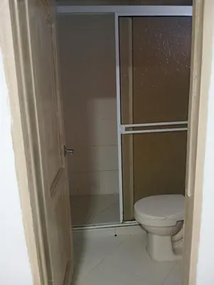 a bathroom with a toilet and a glass shower at CABAÑAS CALIPSO, 2 piso in Coveñas